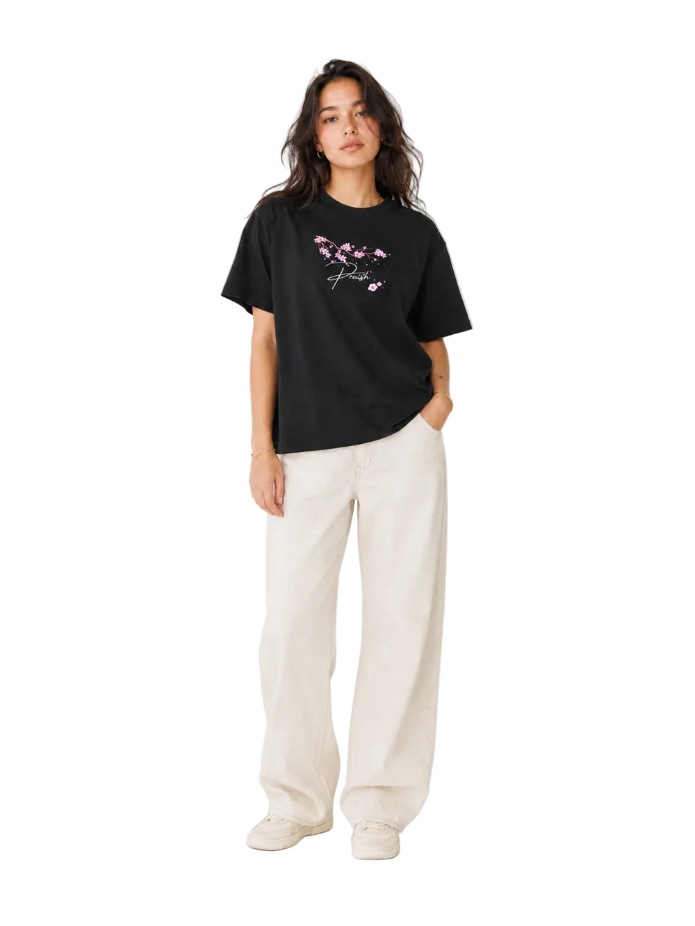 mowearing a black t-shirt with a floral design and white pants on a white background | PRAISH premium streetwear clothing